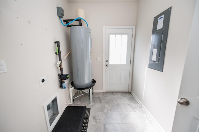 doorway featuring water heater, electric panel, and baseboards