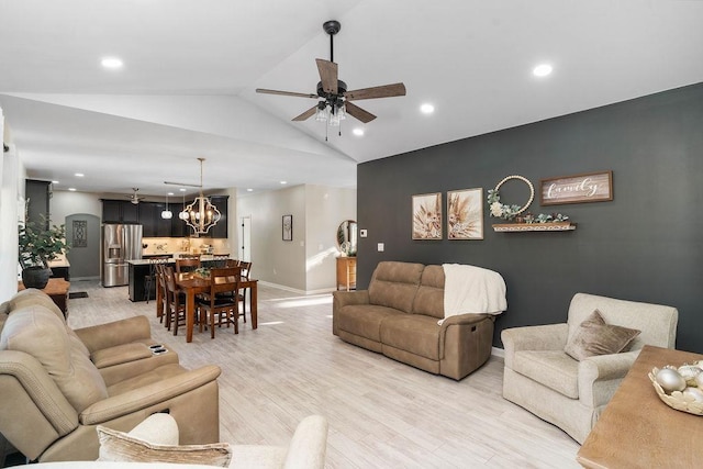 living area featuring light wood finished floors, baseboards, lofted ceiling, ceiling fan with notable chandelier, and recessed lighting