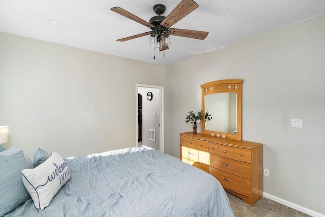 bedroom with baseboards, ceiling fan, visible vents, and light colored carpet