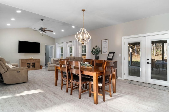 dining area featuring recessed lighting, lofted ceiling, light wood-style flooring, french doors, and ceiling fan with notable chandelier