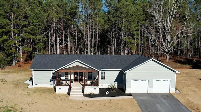 view of front of home featuring a garage, a porch, crawl space, and aphalt driveway