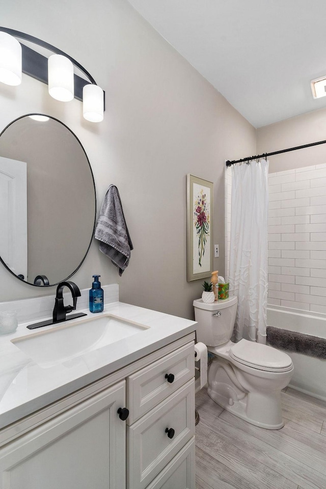 bathroom with visible vents, toilet, shower / tub combo, vanity, and wood finished floors