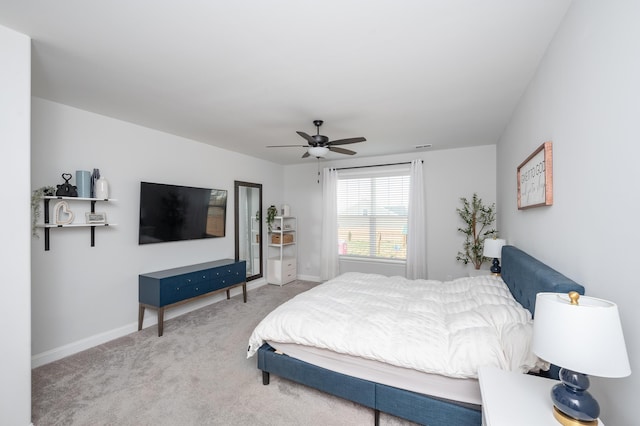 carpeted bedroom featuring ceiling fan and baseboards