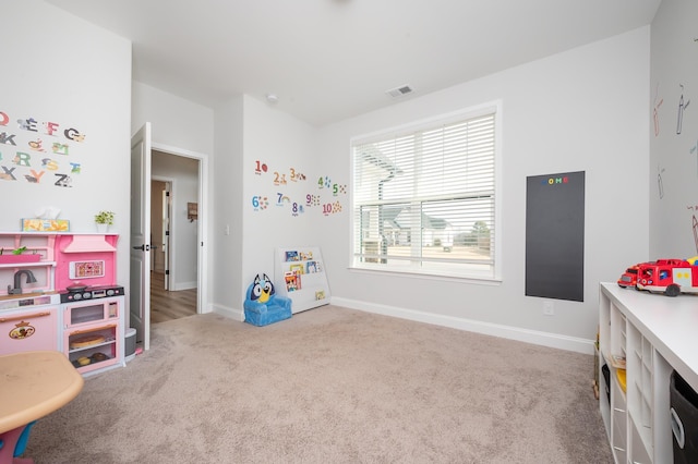 game room with carpet flooring, visible vents, and baseboards