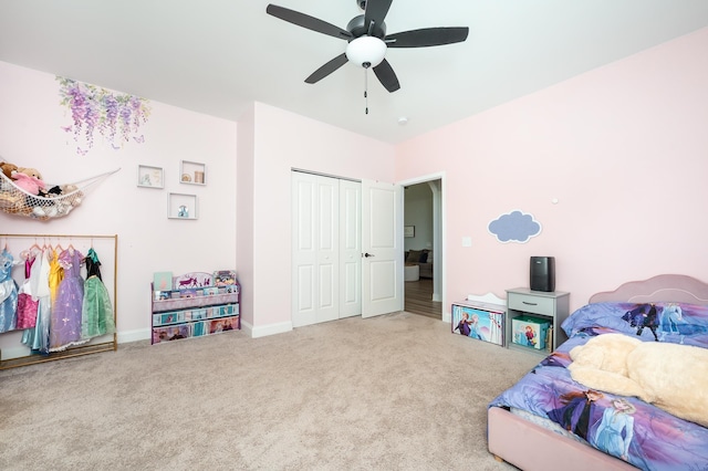 carpeted bedroom featuring a ceiling fan, a closet, and baseboards