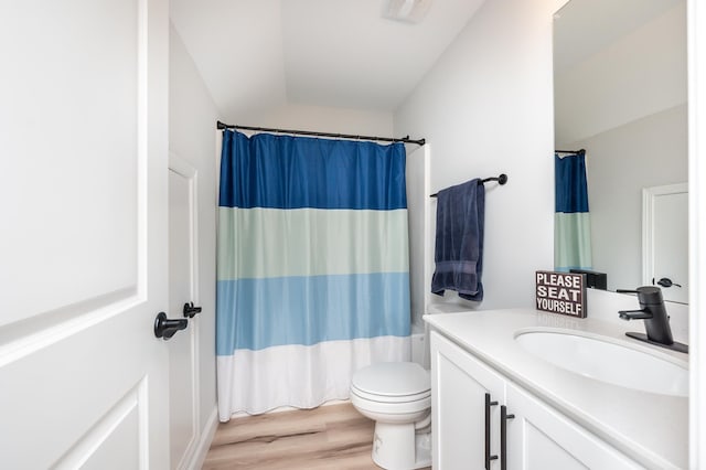 full bathroom featuring toilet, curtained shower, wood finished floors, and vanity