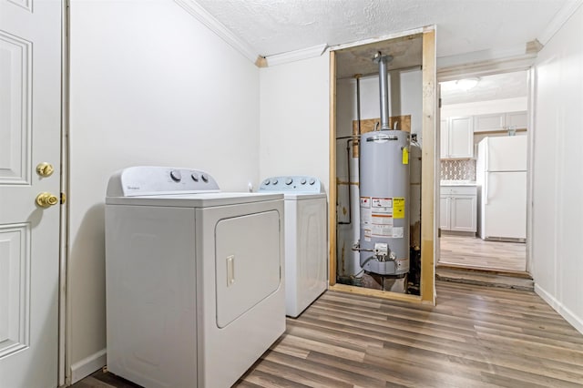 laundry room featuring laundry area, water heater, independent washer and dryer, and wood finished floors