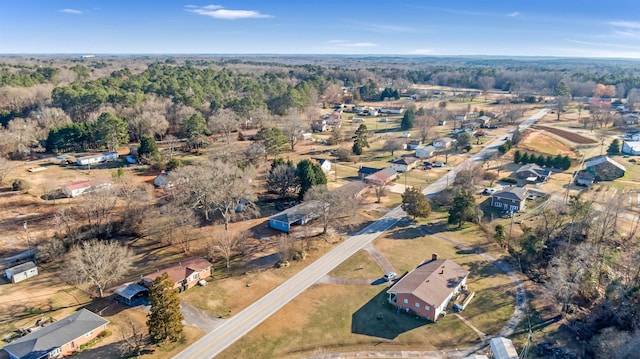 birds eye view of property featuring a view of trees