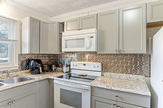 kitchen featuring ornamental molding, white appliances, gray cabinets, and decorative backsplash