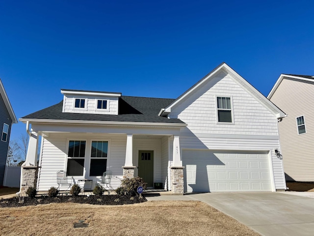 view of front of house with a garage, concrete driveway, a porch, and a shingled roof