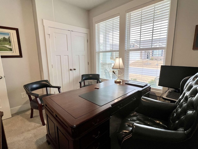 office with light carpet and baseboards