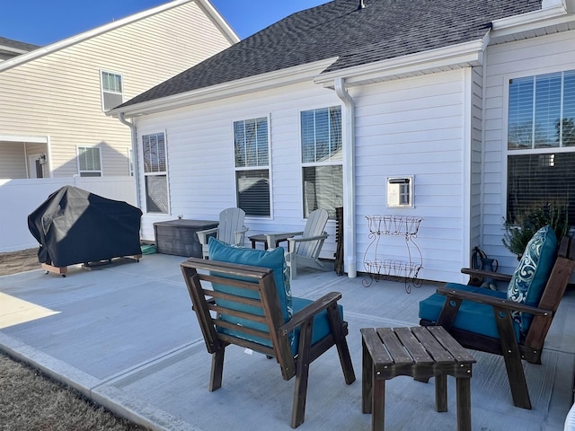 view of patio with an outdoor hangout area, fence, and grilling area