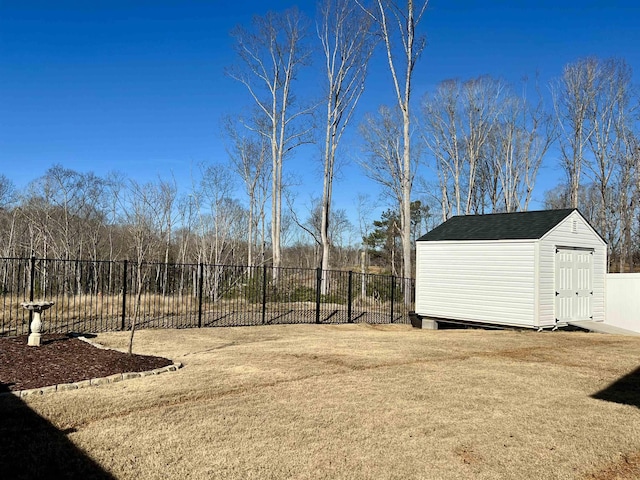 view of yard with fence, an outdoor structure, and a shed