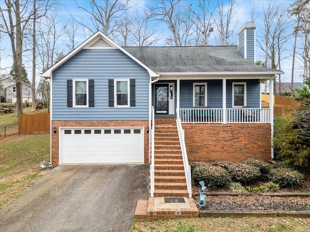 ranch-style house with a garage, aphalt driveway, covered porch, stairs, and fence