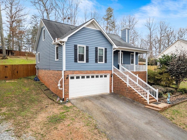 ranch-style house featuring aphalt driveway, a chimney, a porch, stairway, and a garage