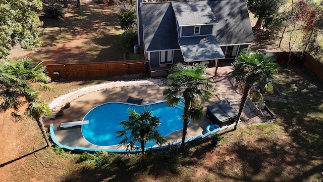 view of pool featuring fence, a diving board, and a fenced in pool