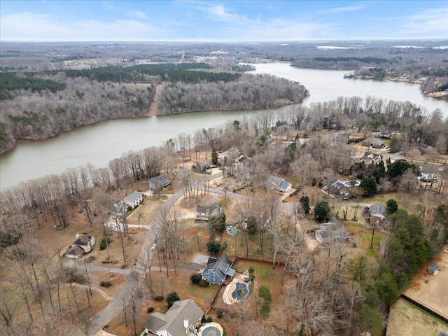 aerial view with a water view and a forest view