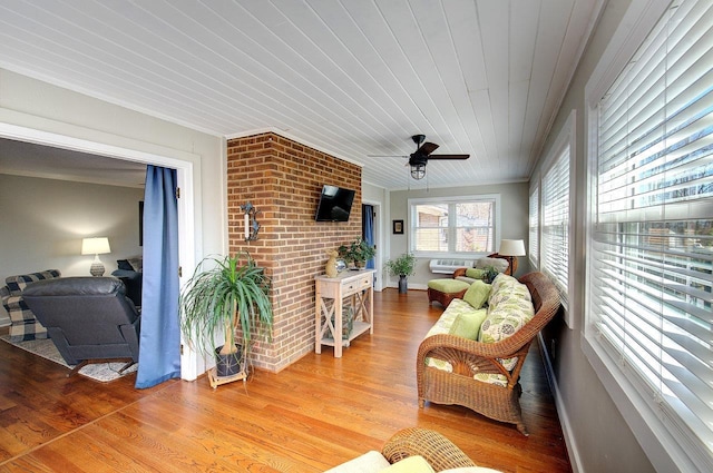 sunroom featuring wooden ceiling and ceiling fan