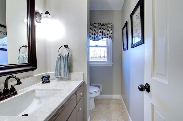 half bath featuring baseboards, visible vents, toilet, tile patterned floors, and vanity