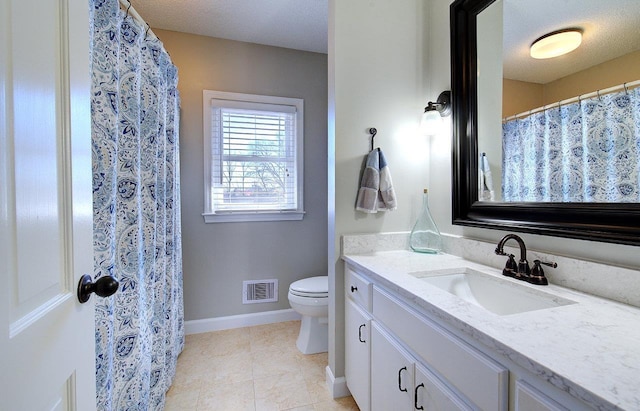 full bathroom with visible vents, toilet, vanity, a textured ceiling, and baseboards