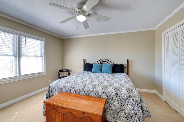 bedroom with baseboards, ornamental molding, a textured ceiling, and light colored carpet