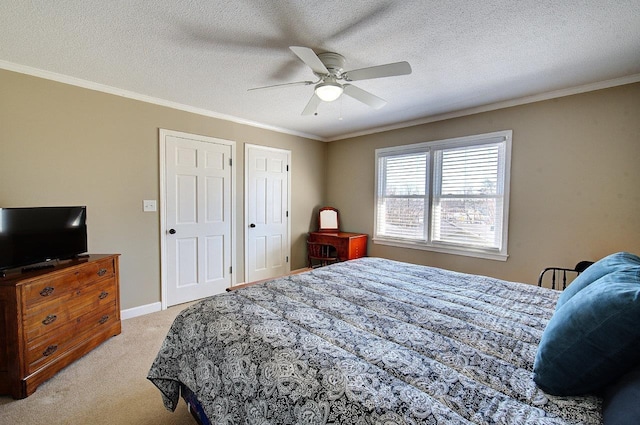 bedroom with a textured ceiling, baseboards, crown molding, and light colored carpet