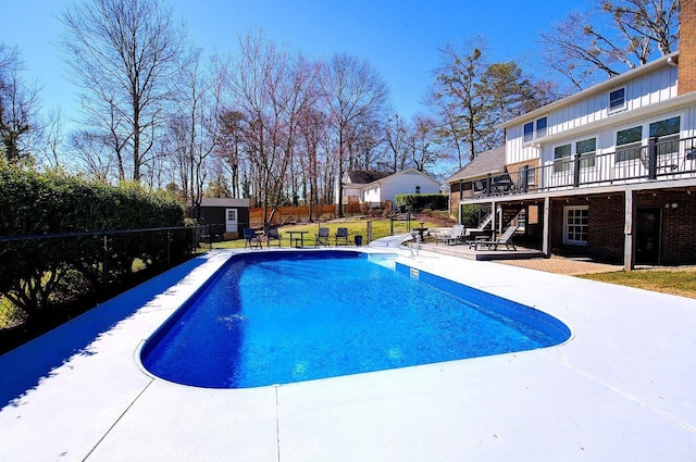 view of swimming pool with a fenced in pool, a patio, stairs, a deck, and an outdoor structure