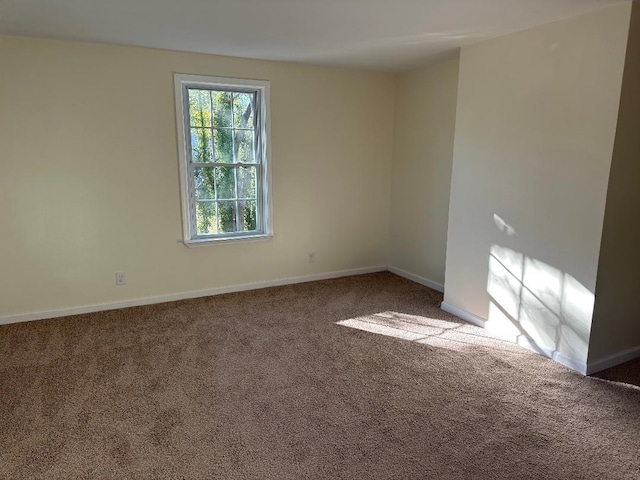 empty room with carpet floors and baseboards