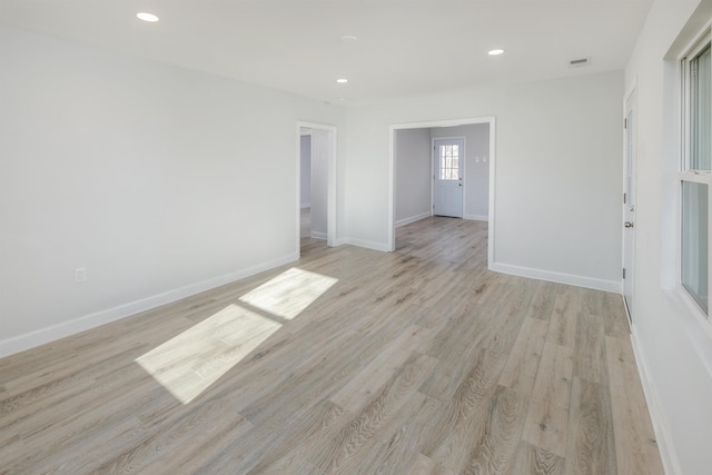 unfurnished room with light wood-style floors, recessed lighting, and baseboards