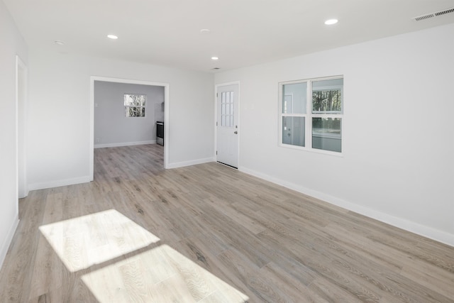 unfurnished room featuring light wood-style floors, recessed lighting, and baseboards