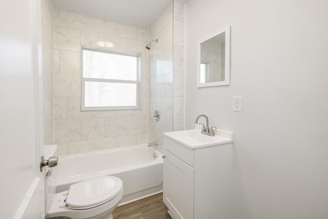 full bathroom with wood finished floors, shower / bath combination, vanity, and toilet