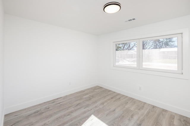 unfurnished room featuring light wood finished floors and baseboards