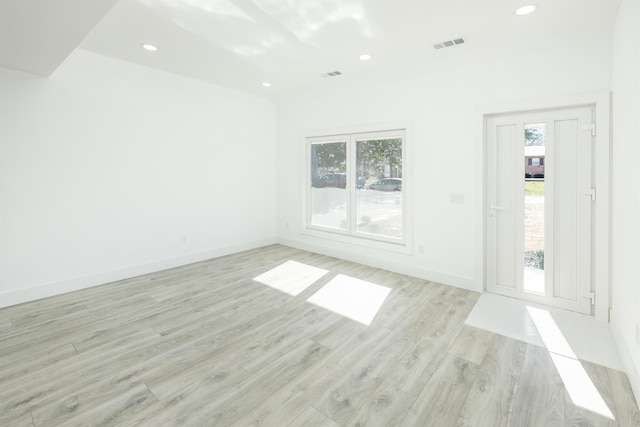 spare room with a wealth of natural light, recessed lighting, visible vents, and light wood-style floors