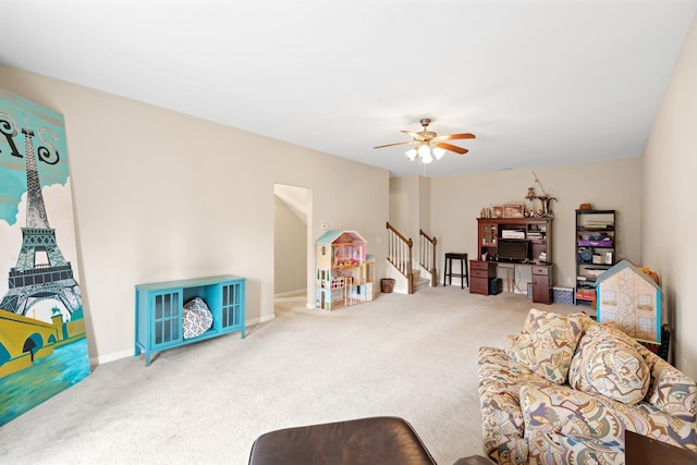 living room featuring a ceiling fan, stairway, and carpet flooring