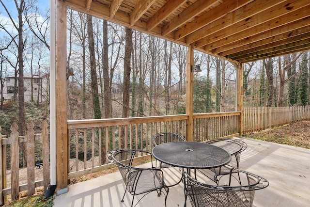 wooden deck featuring outdoor dining area and a patio area