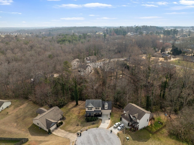 birds eye view of property with a forest view