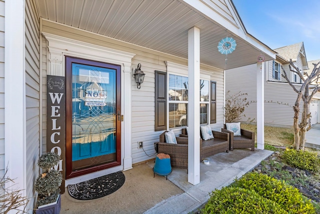 view of exterior entry with a porch