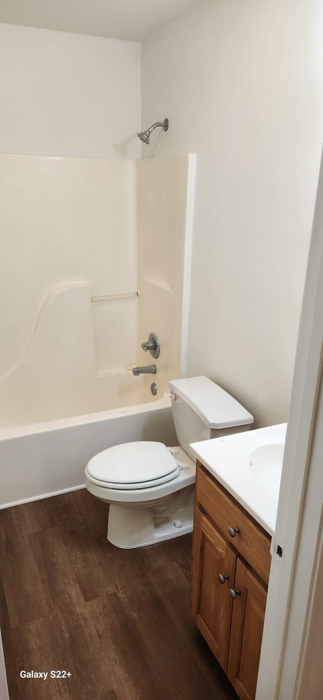 bathroom featuring vanity, shower / bath combination, wood finished floors, and toilet