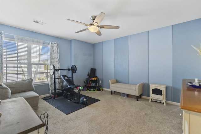 workout area featuring carpet, visible vents, ceiling fan, and baseboards