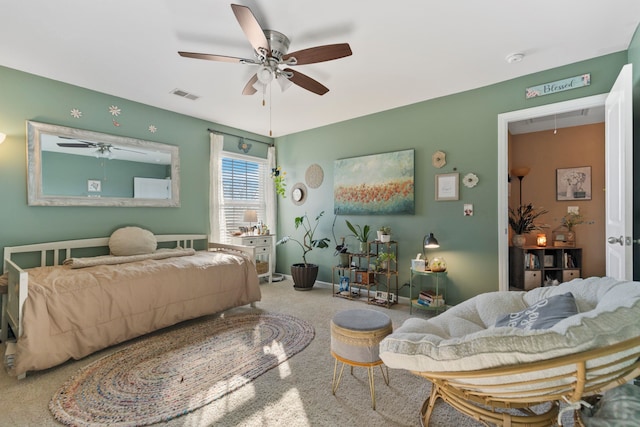 bedroom featuring carpet floors, visible vents, attic access, a ceiling fan, and baseboards