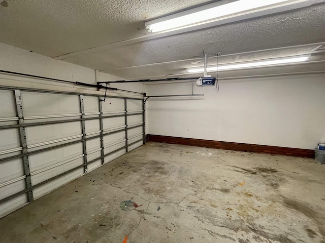 garage featuring baseboards and a garage door opener