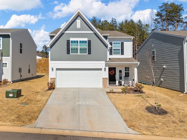 craftsman inspired home with a garage, brick siding, concrete driveway, board and batten siding, and a front yard