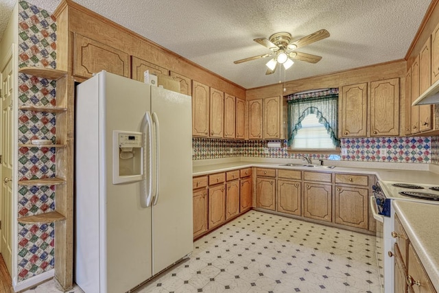 kitchen featuring white appliances, ornamental molding, light countertops, light floors, and a sink