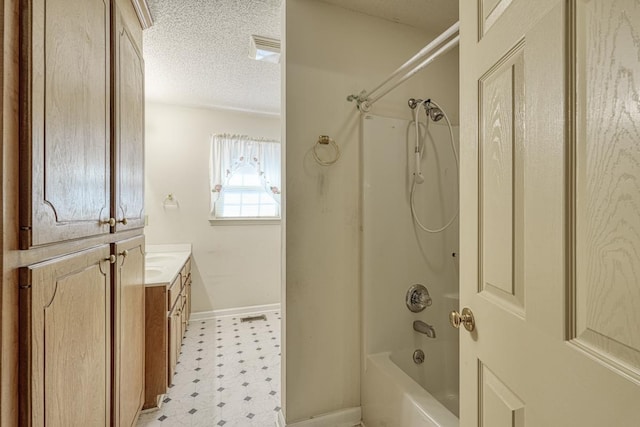 full bath featuring baseboards, tile patterned floors, bathtub / shower combination, a textured ceiling, and vanity