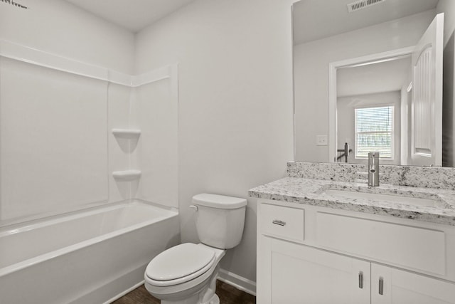 bathroom featuring visible vents, shower / bathing tub combination, toilet, vanity, and baseboards