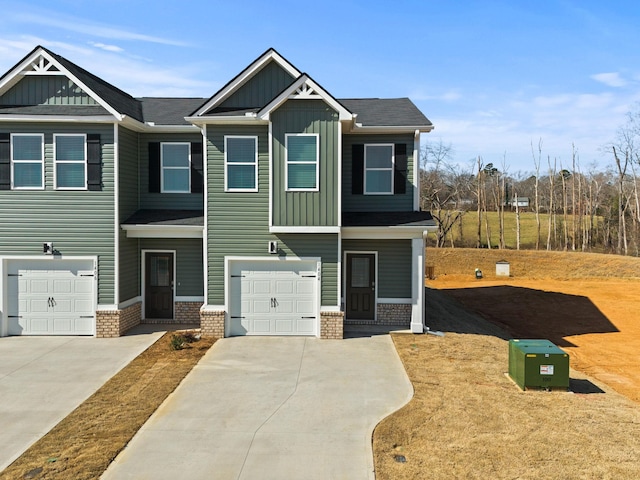 craftsman-style house featuring board and batten siding, brick siding, driveway, and a garage