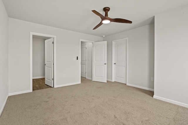 unfurnished bedroom with carpet, ceiling fan, and baseboards