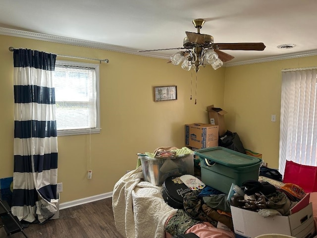 bedroom featuring crown molding, visible vents, ceiling fan, wood finished floors, and baseboards