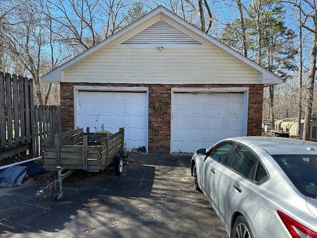 detached garage featuring fence