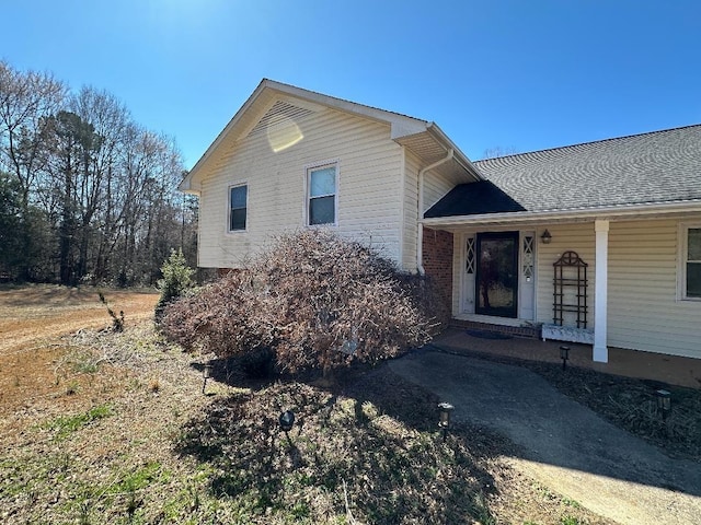 view of front of home with a porch and roof with shingles